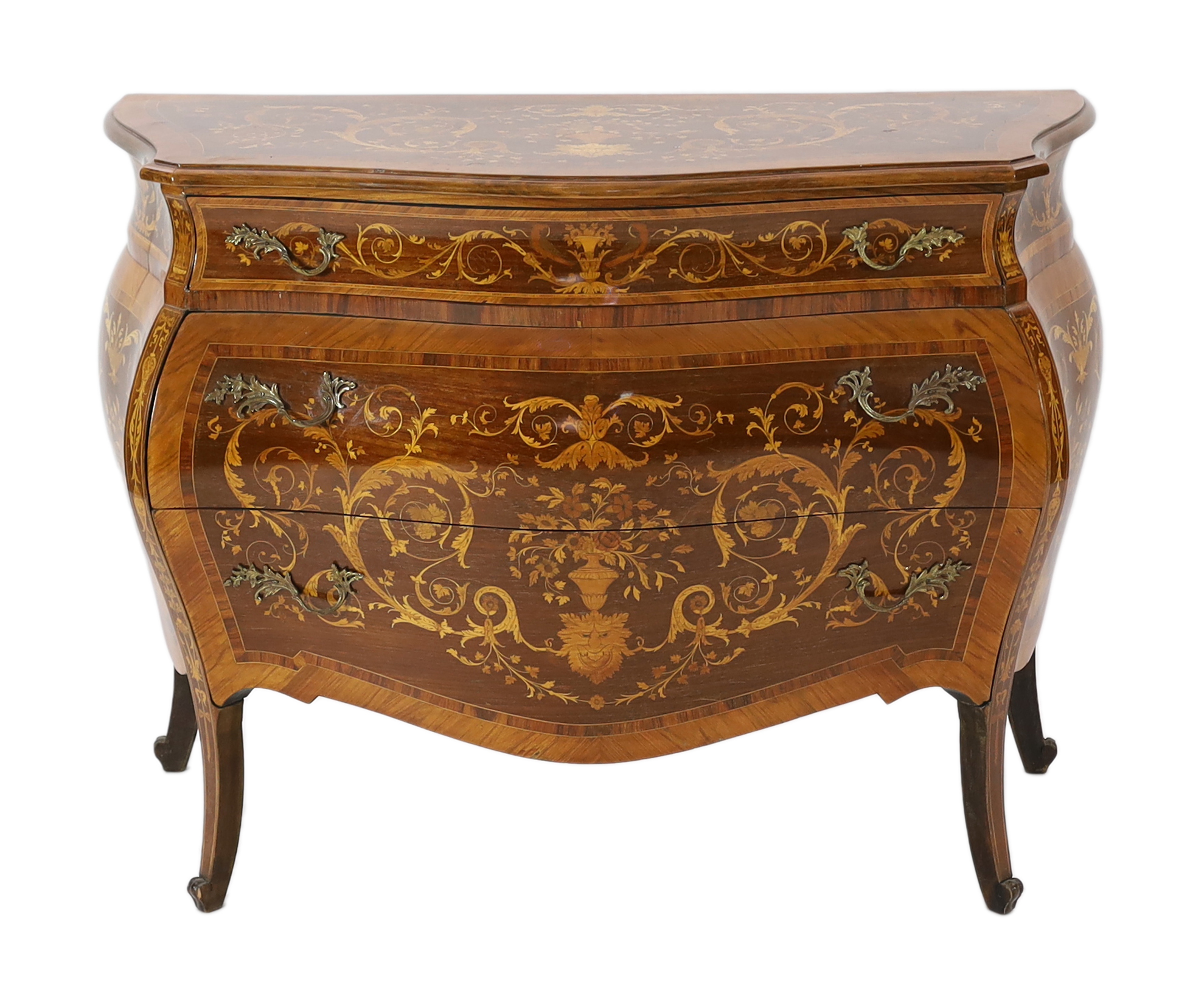 A Continental marquetry inlaid serpentine bombé commode, 130cm wide, 54cm deep, 94cm high